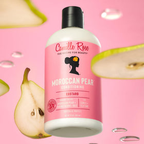 Camille Rose in-use image applying conditioner in shower for smoother detangling