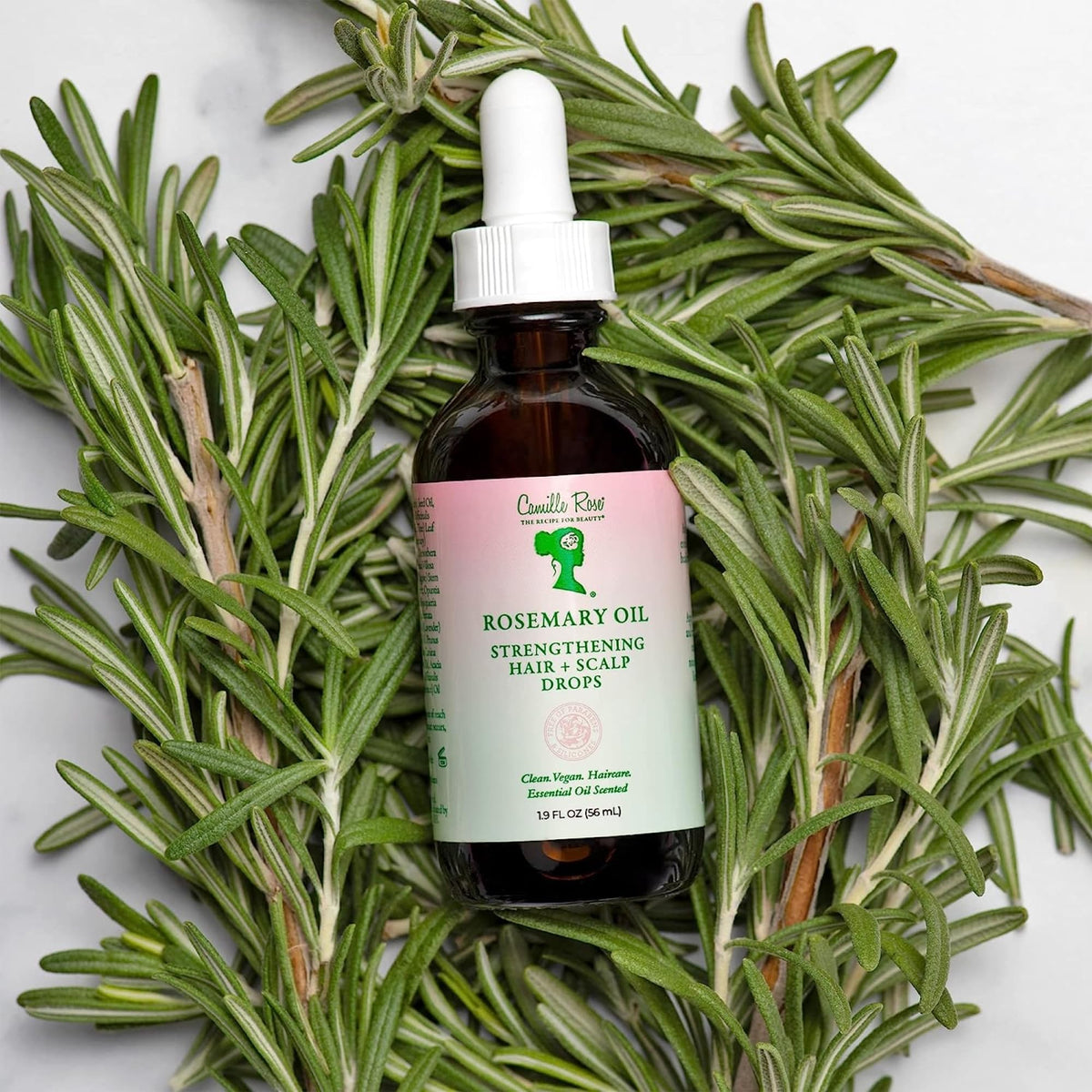 Camille Rose oil applied to hair ends showing split-end smoothing benefit