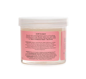 Camille Rose 12 oz jar next to a hand for scale to show practical size for home use