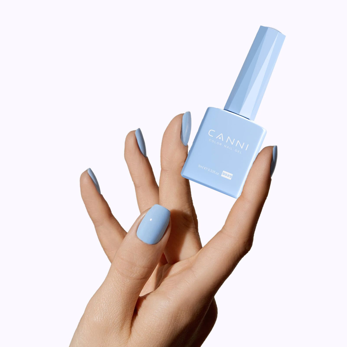 CANNI next to a hand for scale to show bottle size and usability
