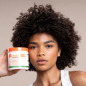 Cantu jar in hand next to ruler for scale showing generous 16 oz size