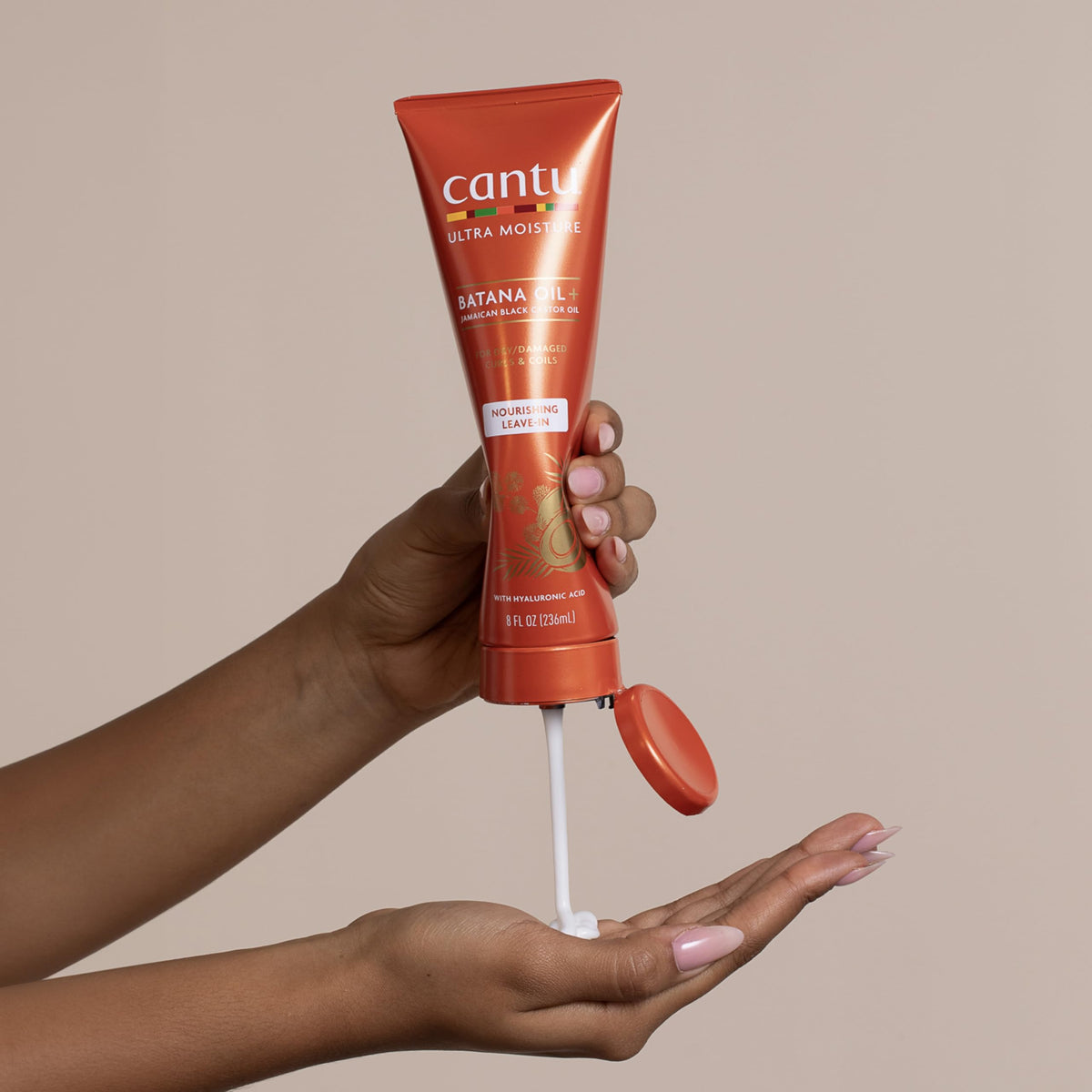 Cantu 8 fl oz bottle in hand showing true size and travel-friendly benefit