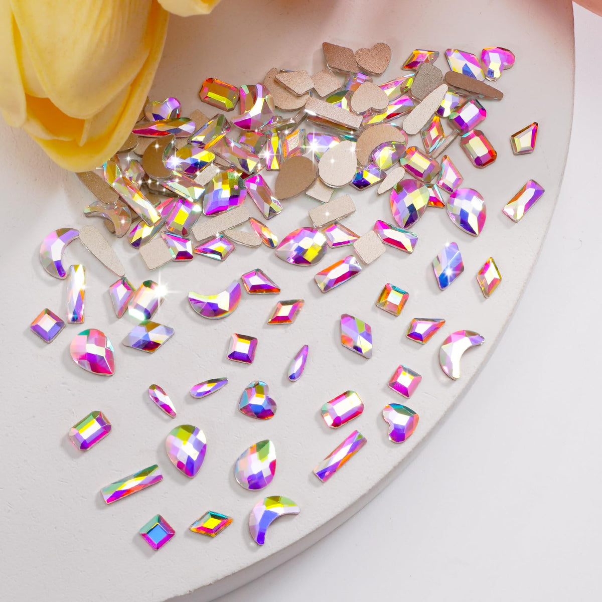 CANVALITE tweezers and wax picker beside gems for precise, mess-free placement