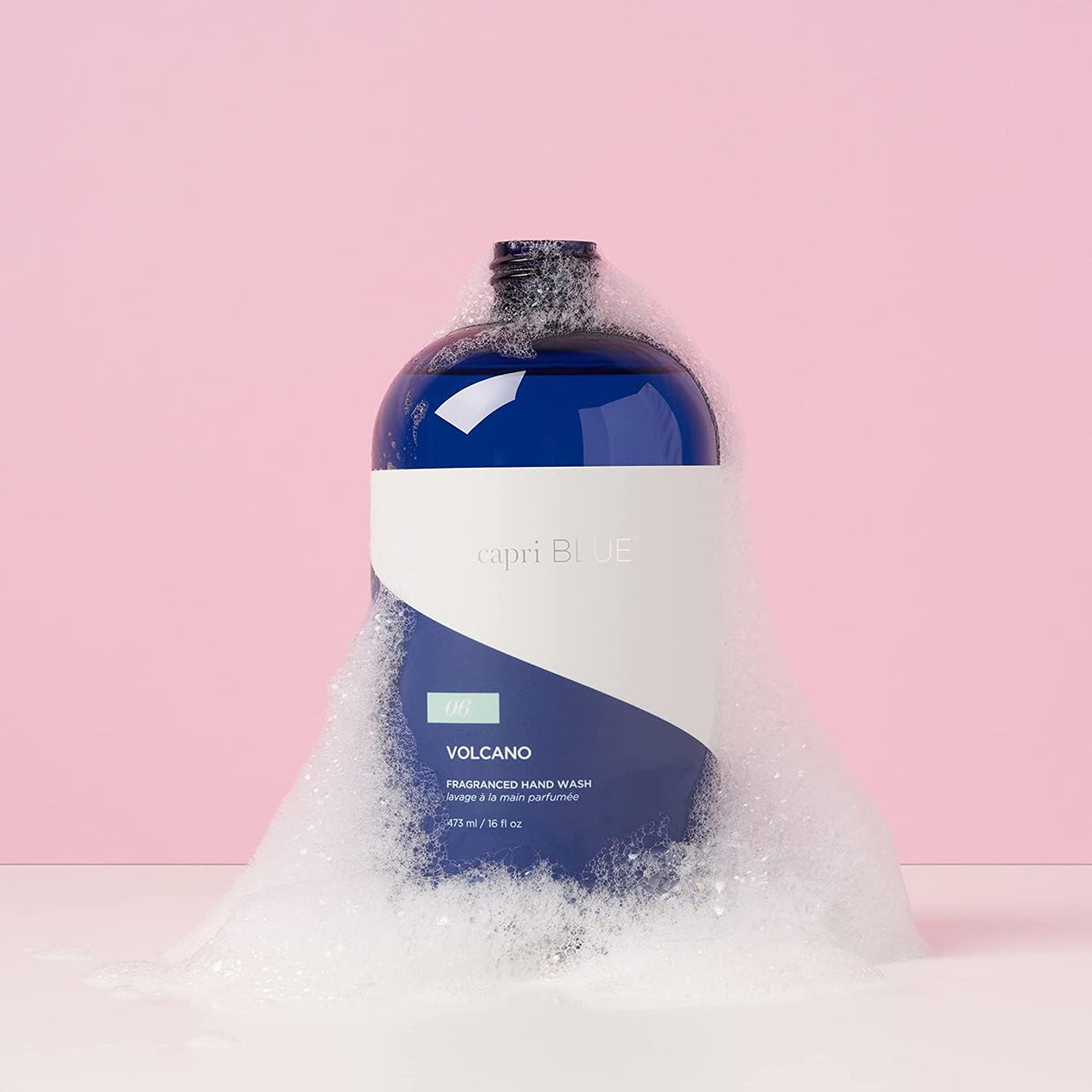 Capri Blue Volcano refill being poured into a pump bottle for convenient refill benefit