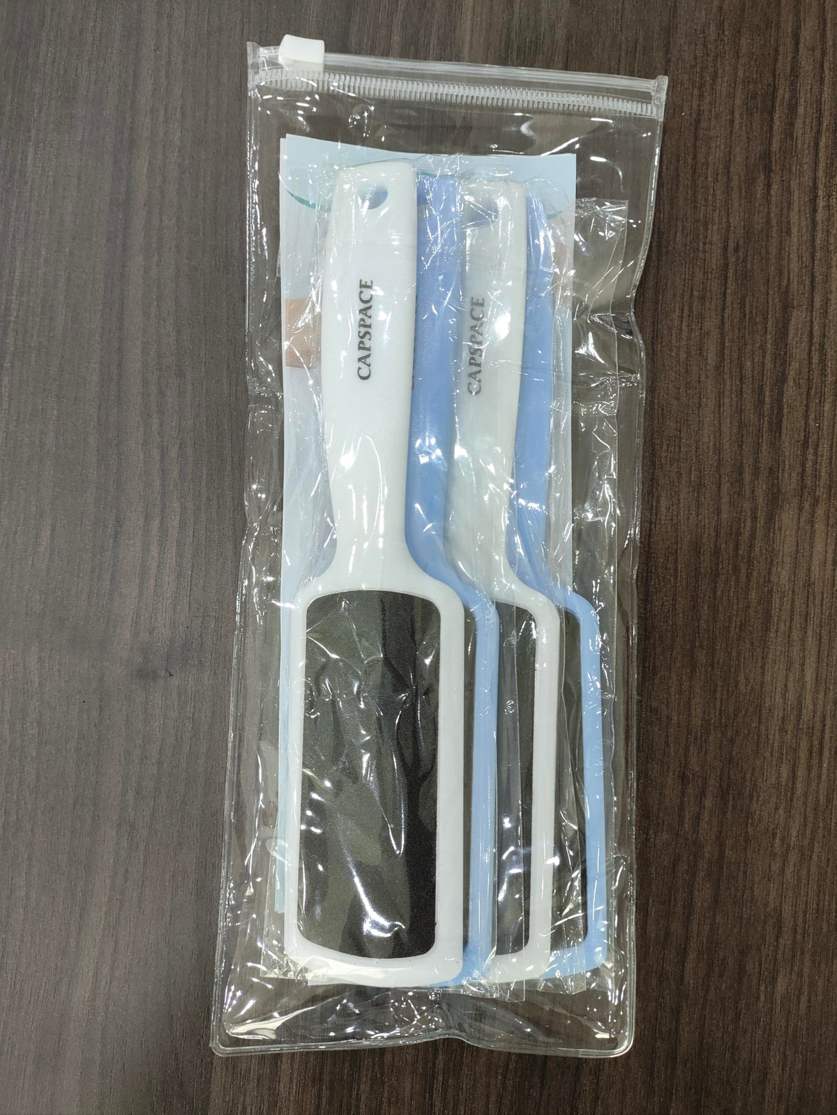 Capspace two colors white and blue displayed for color-coded household or shared use