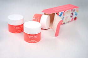 CARE:NEL hand holding a 5g pot demonstrating compact travel-friendly size