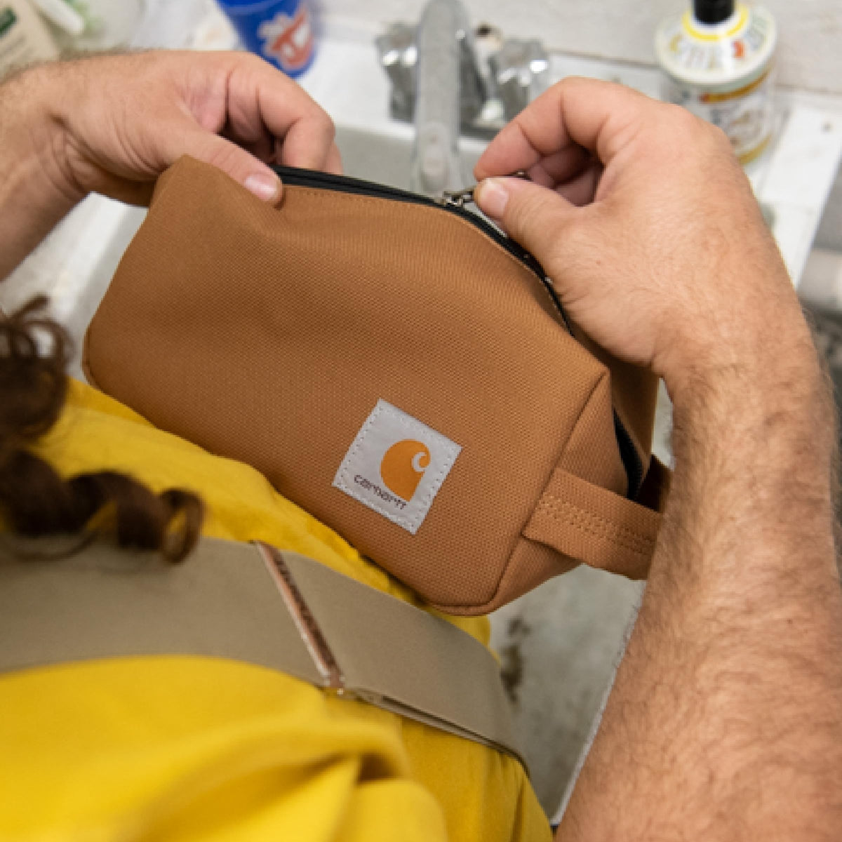 Carhartt travel kit staged in hotel bathroom showing professional look and countertop order