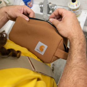 Carhartt travel kit staged in hotel bathroom showing professional look and countertop order