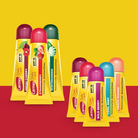 Carmex full-size tube close-up highlighting texture and long-lasting moisture