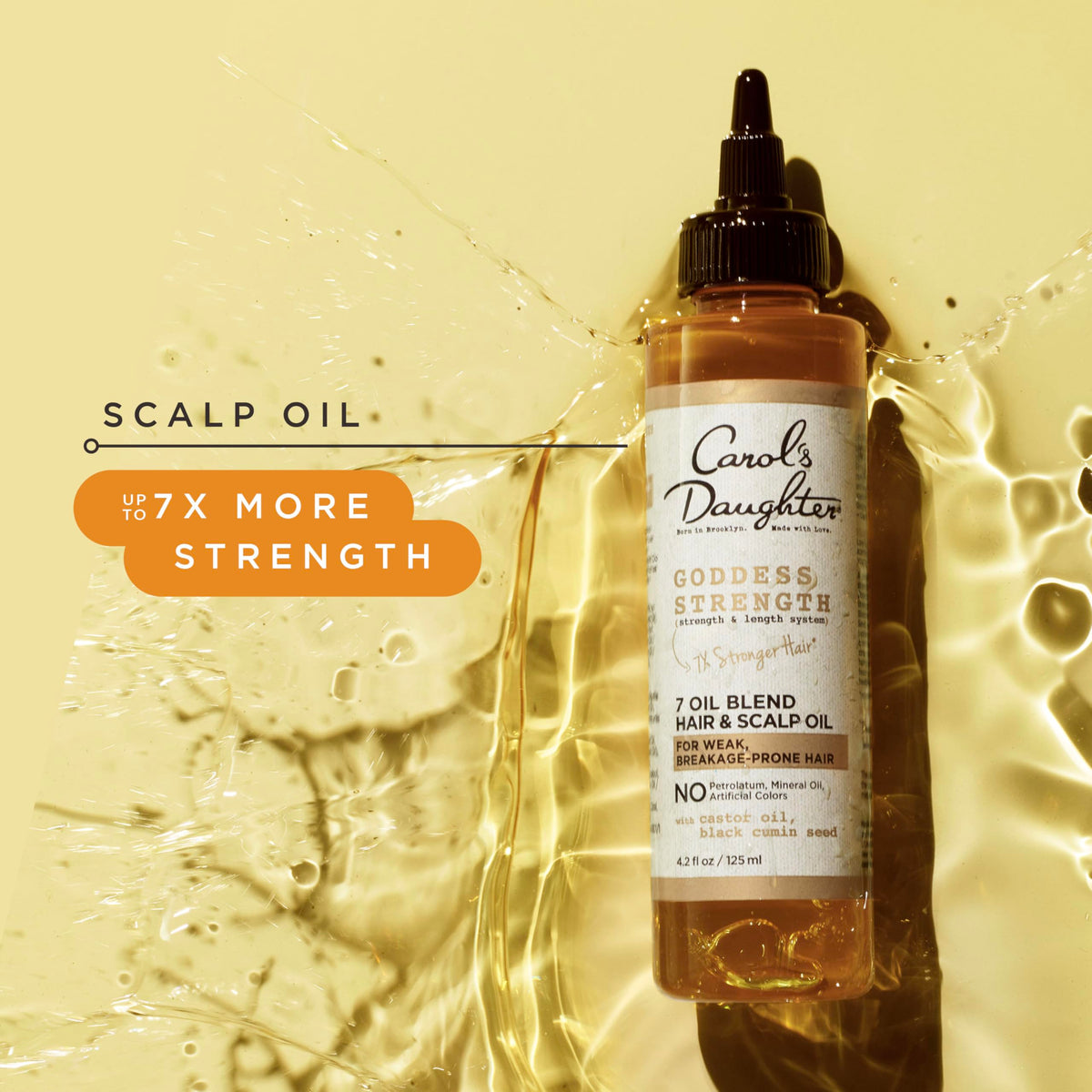 Carol's Daughter applying oil to scalp demonstrating targeted hydration benefit