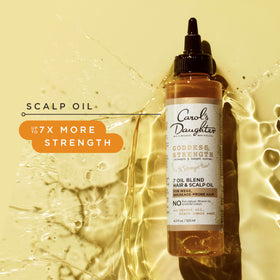 Carol's Daughter applying oil to scalp demonstrating targeted hydration benefit