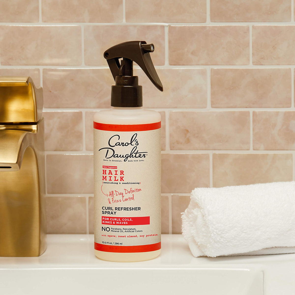 Carol's Daughter bottle in hand to show 10 fl oz scale and travel-friendly benefit