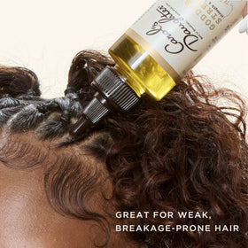 Carol's Daughter oil texture on hand highlighting lightweight absorption benefit