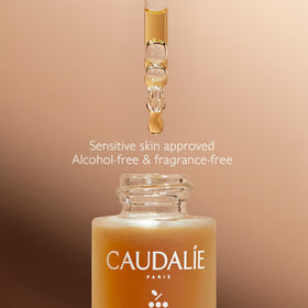 Caudalie 15 mL bottle in hand for scale, compact travel-friendly size advantage