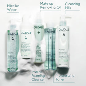 Caudalie bottle held in hand to illustrate 150 mL size and portability