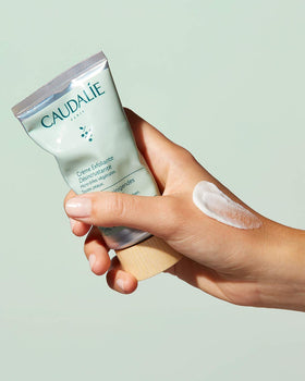 Caudalie product being applied to hand demonstrating easy spread and refreshing feel