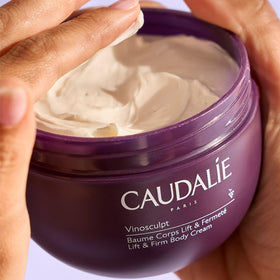 Caudalie Vinosculpt applied in hands and massaged onto leg demonstrating firming and smoothing benefit