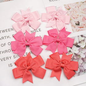 CÉLLOT bow beside coin for clear size and scale reference