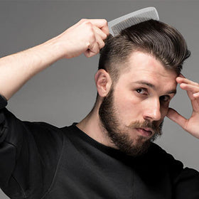 CGBARBER combs beside a ruler showing compact size and scale for travel