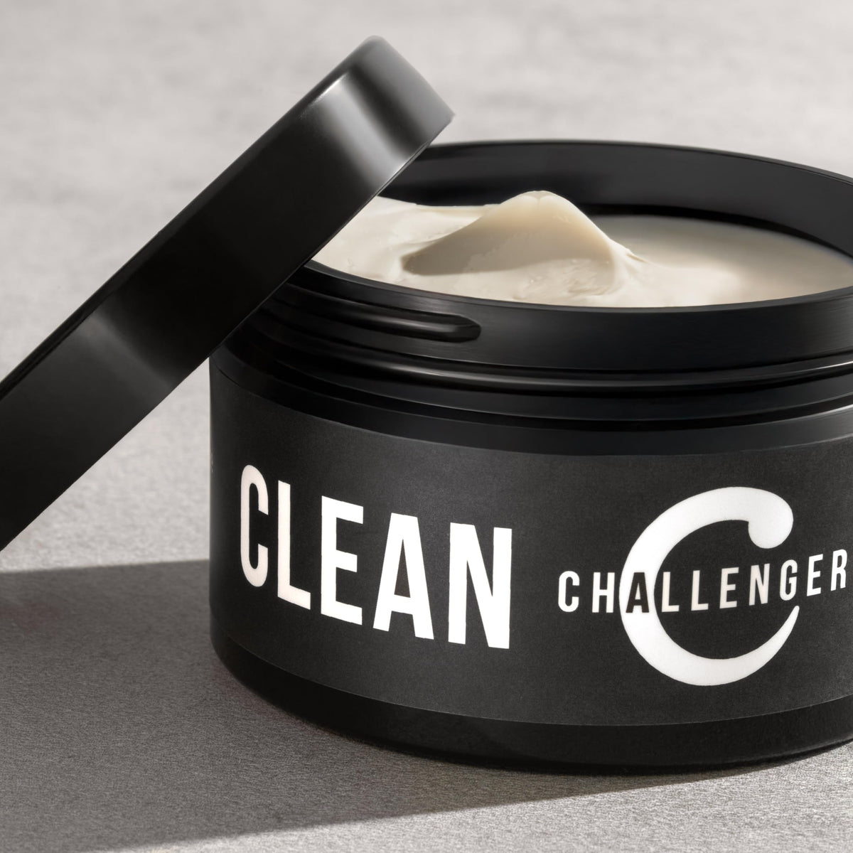 Challenger rinsing under water to show water-soluble formula and easy cleanup