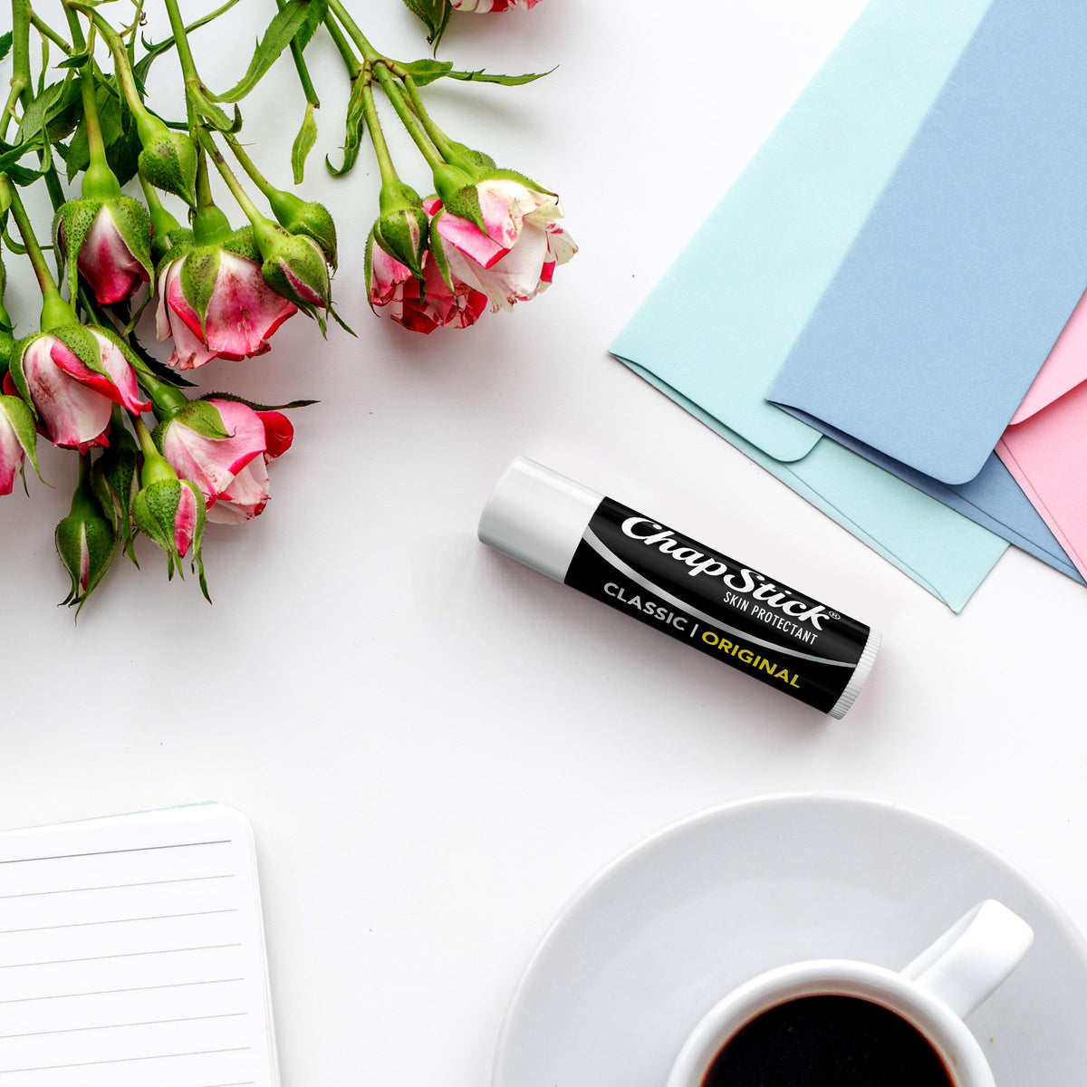 ChapStick Classic next to coin showing compact 0.15 oz size for portability