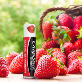 ChapStick strawberry being applied to lips showing quick soothing effect