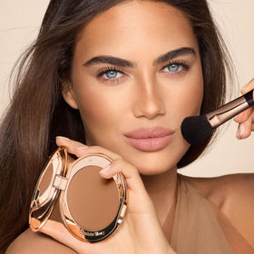 Charlotte Tilbury bronzer pan close-up highlighting finely milled powder and smooth finish