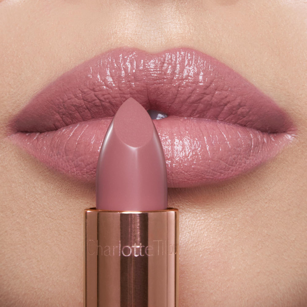 Charlotte Tilbury closeup lips wearing pillow talk fair for luminous fuller look