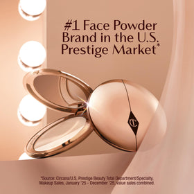 Charlotte Tilbury application with powder brush depicting even pickup and blendability