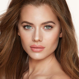 Charlotte Tilbury swatches on skin illustrating buildable bronzer and luminous highlight