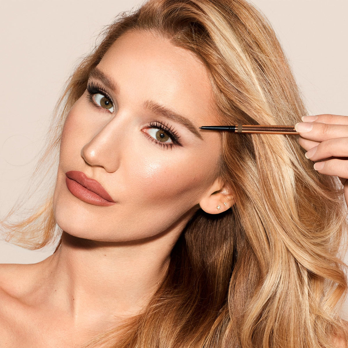 Charlotte Tilbury refill cartridge next to pencil highlighting sustainability and easy replacement