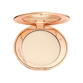 Charlotte Tilbury compact front showing sleek packaging and portability benefit