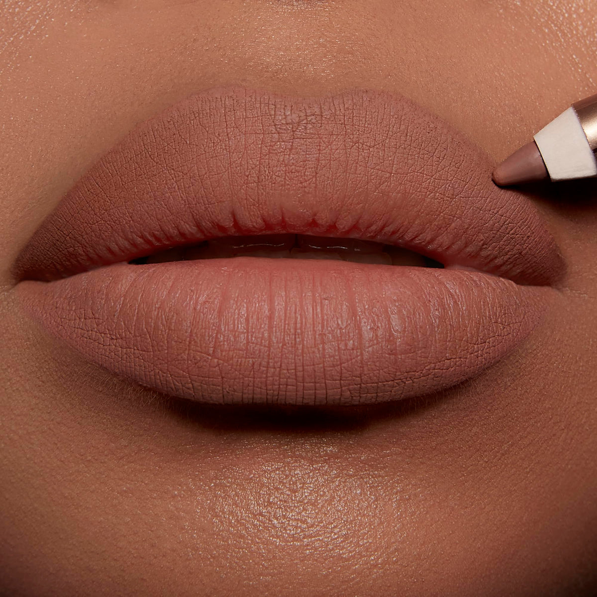 Charlotte Tilbury demo on model lips illustrating Iconic Nude creating fuller-looking, defined pout