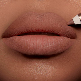 Charlotte Tilbury demo on model lips illustrating Iconic Nude creating fuller-looking, defined pout