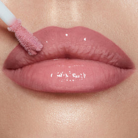 Charlotte Tilbury gloss held in hand to show supersize tube and scale