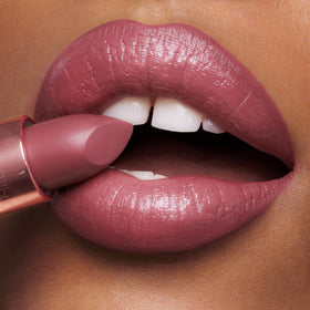 Charlotte Tilbury mini lipsticks in hand for size comparison, travel-friendly convenience