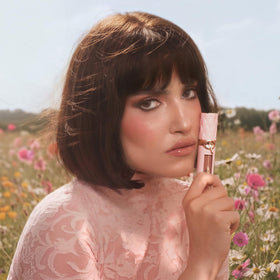 Charlotte Tilbury lifestyle image of model wearing gloss showing daytime fuller lips benefit