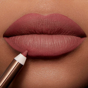 Charlotte Tilbury lip application demonstrating defined lips and fuller-look benefit