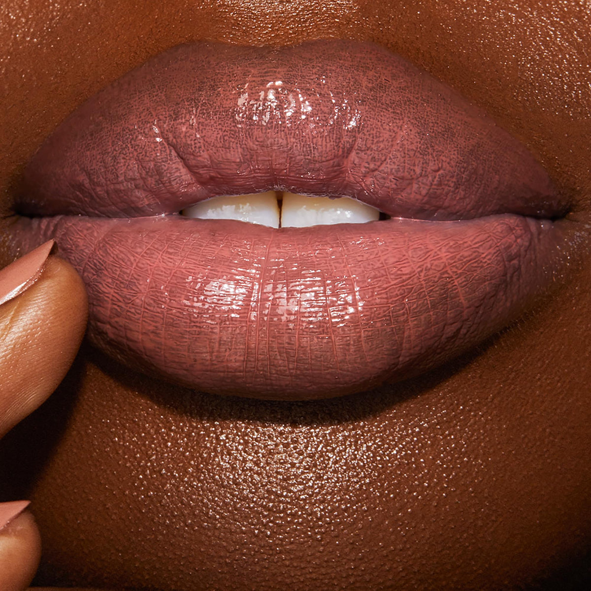 Charlotte Tilbury Pillow Talk swatch on arm showing true nude-pink color payoff