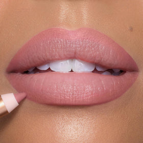 Charlotte Tilbury lip liner on lips with gloss adds fuller-looking shine and polish