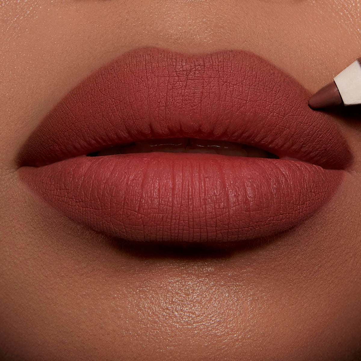Charlotte Tilbury application on lips close-up demonstrating defined fuller-looking pout