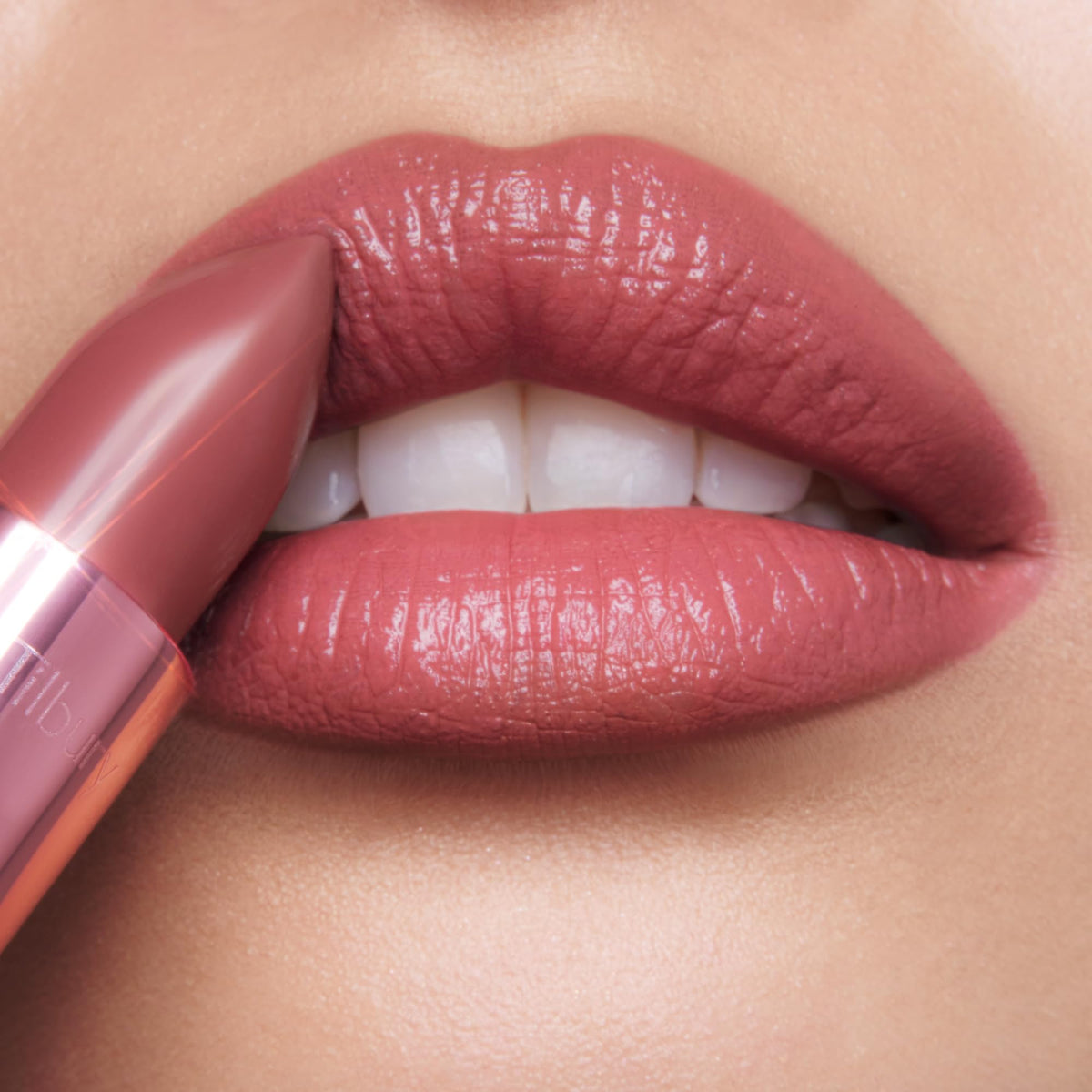 Charlotte Tilbury applying lipstick on model lips, demonstrates easy smooth application