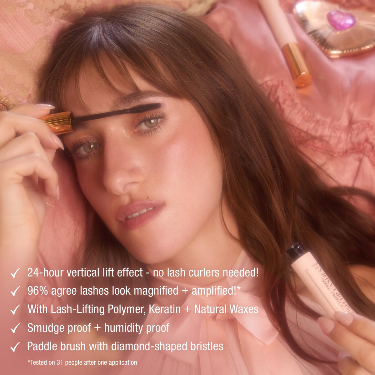 Charlotte Tilbury model applying mascara in mirror showing awake, intensified eyes