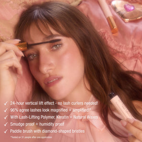Charlotte Tilbury model applying mascara in mirror showing awake, intensified eyes