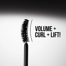 Charlotte Tilbury mascara next to coin scale showing compact travel-friendly size