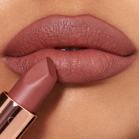Charlotte Tilbury Supermodel shade applied to lips showing flattering mid-toned nude-rose finish
