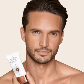 Charlotte Tilbury applied on model in lifestyle setting, showcases hydrated glowing complexion