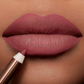 Charlotte Tilbury in hand for size comparison showing travel-friendly length