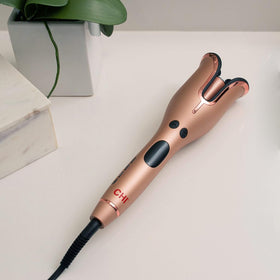 CHI in-use on long hair illustrating automatic curling action for quick, even waves