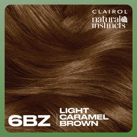 Clairol shade swatch on a single hair strand showing warm caramel tone